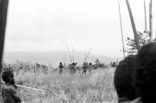 Thru the heads of some warriors at another group in the distance