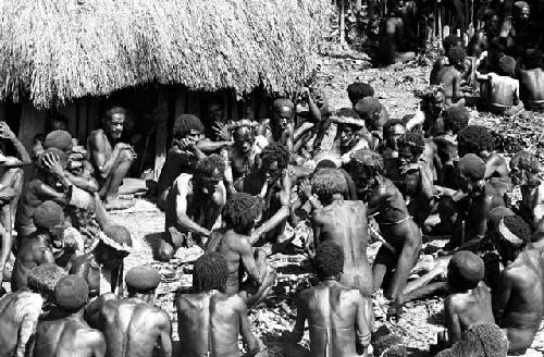 View of men butchering pigs