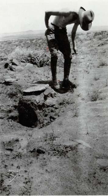 Man standing near adobe walls