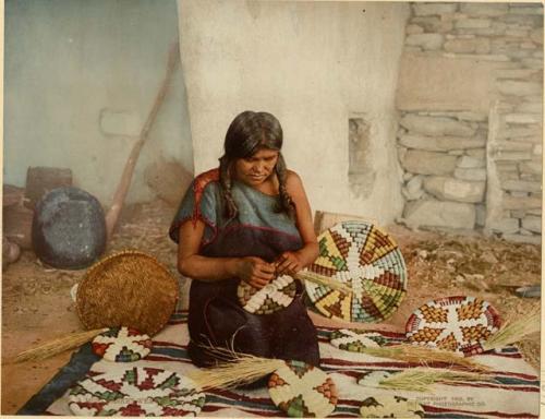 Hopi woman weaving plaque and baskets
