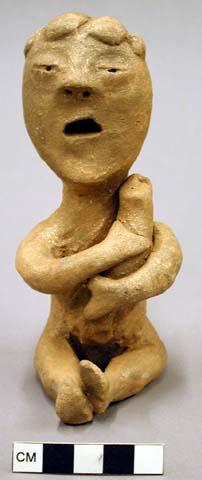 Effigy figurine sitting, holding baby or bundle, micaceous clay - one of 3 seate