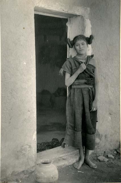 Hopi woman standing in a doorway