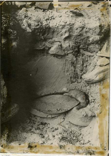 Grave at White Dog Cave. Photo of large dog partly covered by basket.