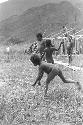 Children beginning to play sikoko wasin; school building going up in the background