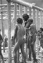 Men of Kibit Silimo watching as the main members of the building are being put into the ground