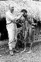 Eliot Elisofon showing his camera to a man in the sili; Abukulmo