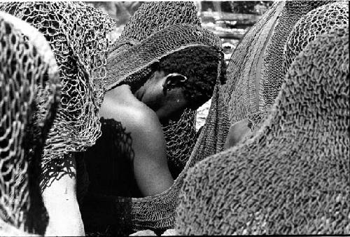 Women's heads bowed in mourning; their nets making nice patterns