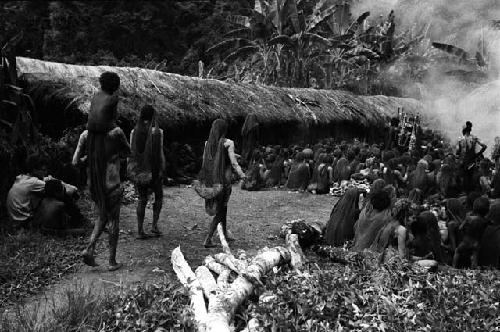 People entering the funeral; Karl Heider to the left