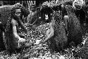 Men working in hakse; taking out some potatoes