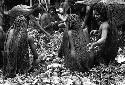 Men working in hakse; taking out some potatoes