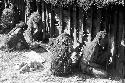 Women huddled against the side of the hunu at Abulupak the day after the funeral for Weaké