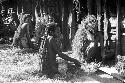 Women huddled against the side of the hunu at Abulupak the day after the funeral for Weaké