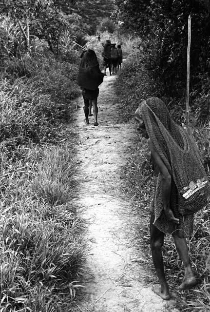 Women walking down the path outside of Abulupak