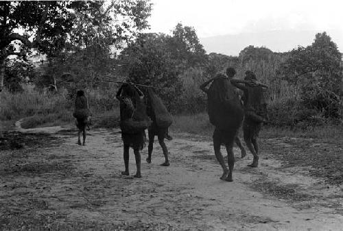 Women walking down the path outside of Abulupak