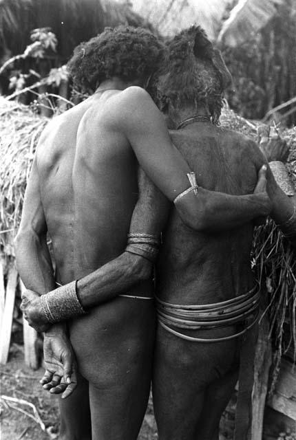 Two men greet each other in mourning