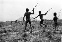 Boys playing sikoko wasin in front of Homoak; Siobara in background