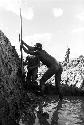 Two men working in deep garden ditch