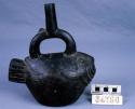 Black pottery jar, mouth on hollow handle