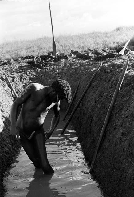 A man washing in the ditch after a day's labor