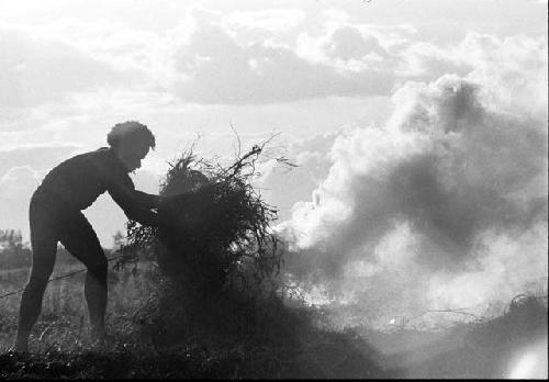 Man piling up trash to burn