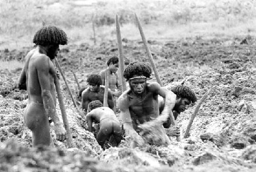 Men clearing a ditch