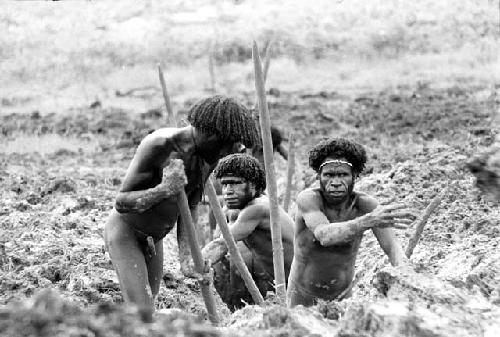 Men clearing a ditch