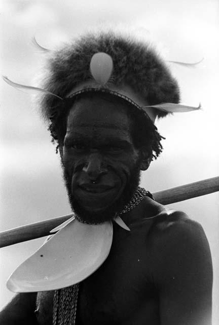 Portrait of a man; mikak, inamossi, spear on his shoulder