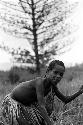 Girl playing sikoko wasin, about to spear a hoop