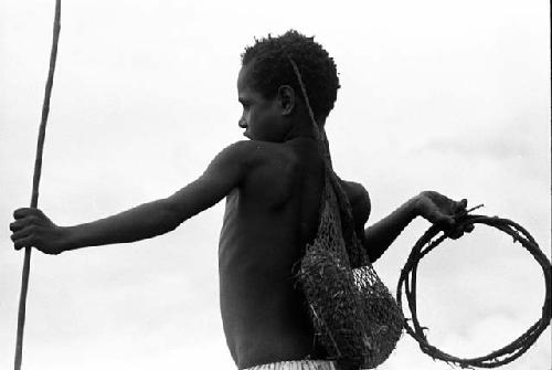 Little girl has her hand cocked to throw a sikoko