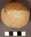 Stone ball or pecking stone. hemispherical small cobble with incrustations cover