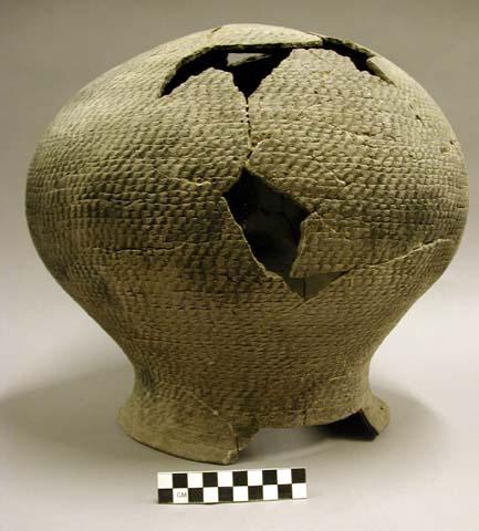 Ceramic jar, corrugated, flat base, flared rim, mended, missing sherds