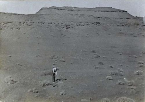 Man searching for graves at a ruin on Little Colorado River