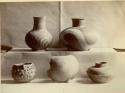Four complete vessels, one broken vessel, various spiral and geometric designs