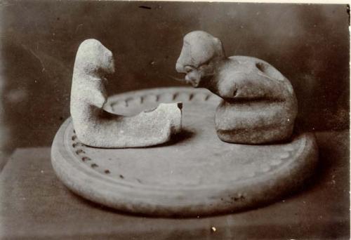 Side view of two human effigies, one kneeling