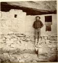 Cliff Palace ruins, Frederick E. Hyde standing by T-shaped door