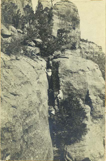 Two men climbing up Indian trail