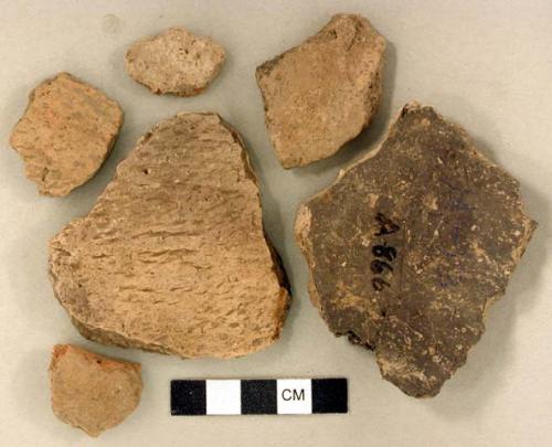 Coarse earthenware body and rim sherds, some cord impressed, some incised, some undecorated