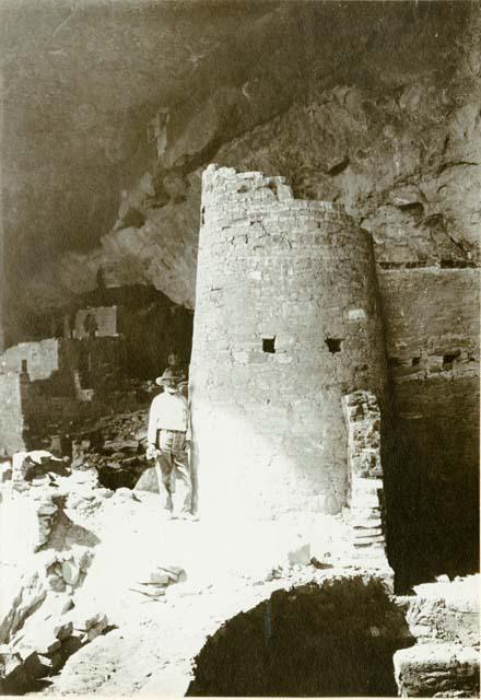 Round Tower of Cliff Palace, with man standing next to it