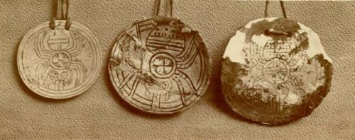 Three inscribed pendants