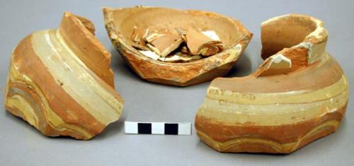 Pottery jar, in fragments, multicolored clay body.