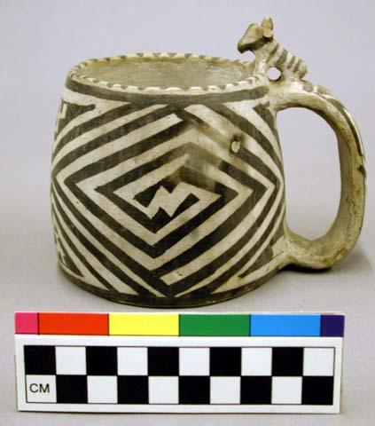 Mug, black on white ware, figure of ram mountain sheep on handle