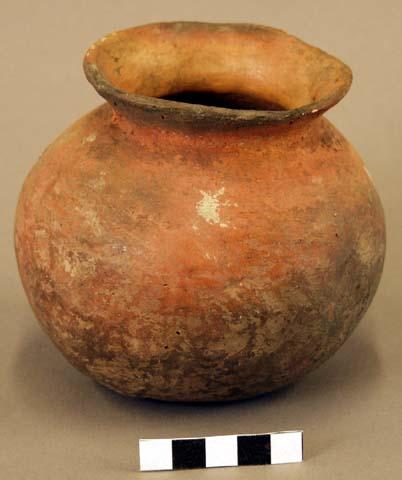 Ceramic jar, flared rim, two perforations at neck, red exterior, fire clouded