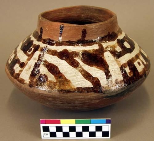 Red jar with white slip and brown glaze