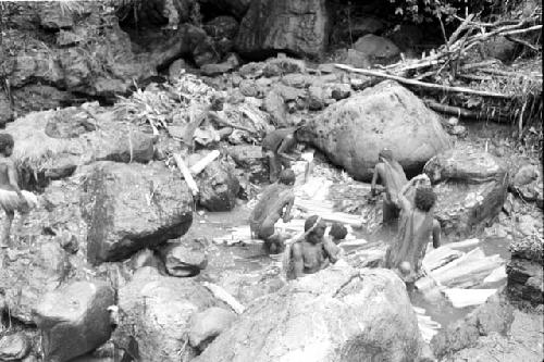 Women and children working in the salt pool at the salt well