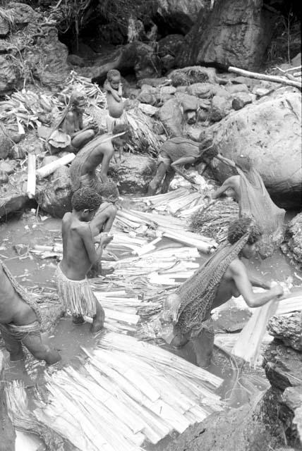 Women and children working in the salt pool at the salt well