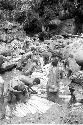 Women and children working in the salt pool at the salt well