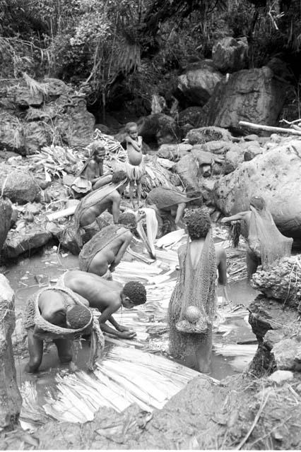 Women and children working in the salt pool at the salt well