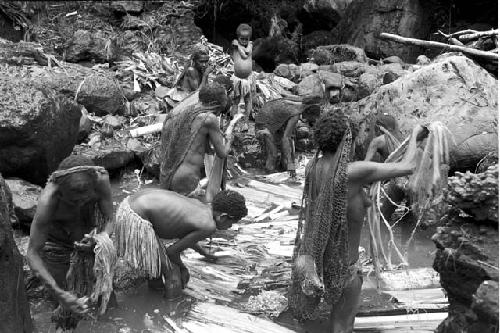 Women and children working in the salt pool at the salt well