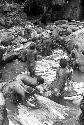 Women and children working in the salt pool at the salt well