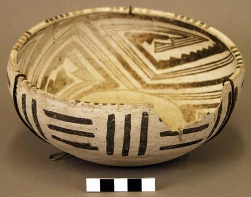 Ceramic bowl, black on white interior&exterior, flat base, rim sherds missing